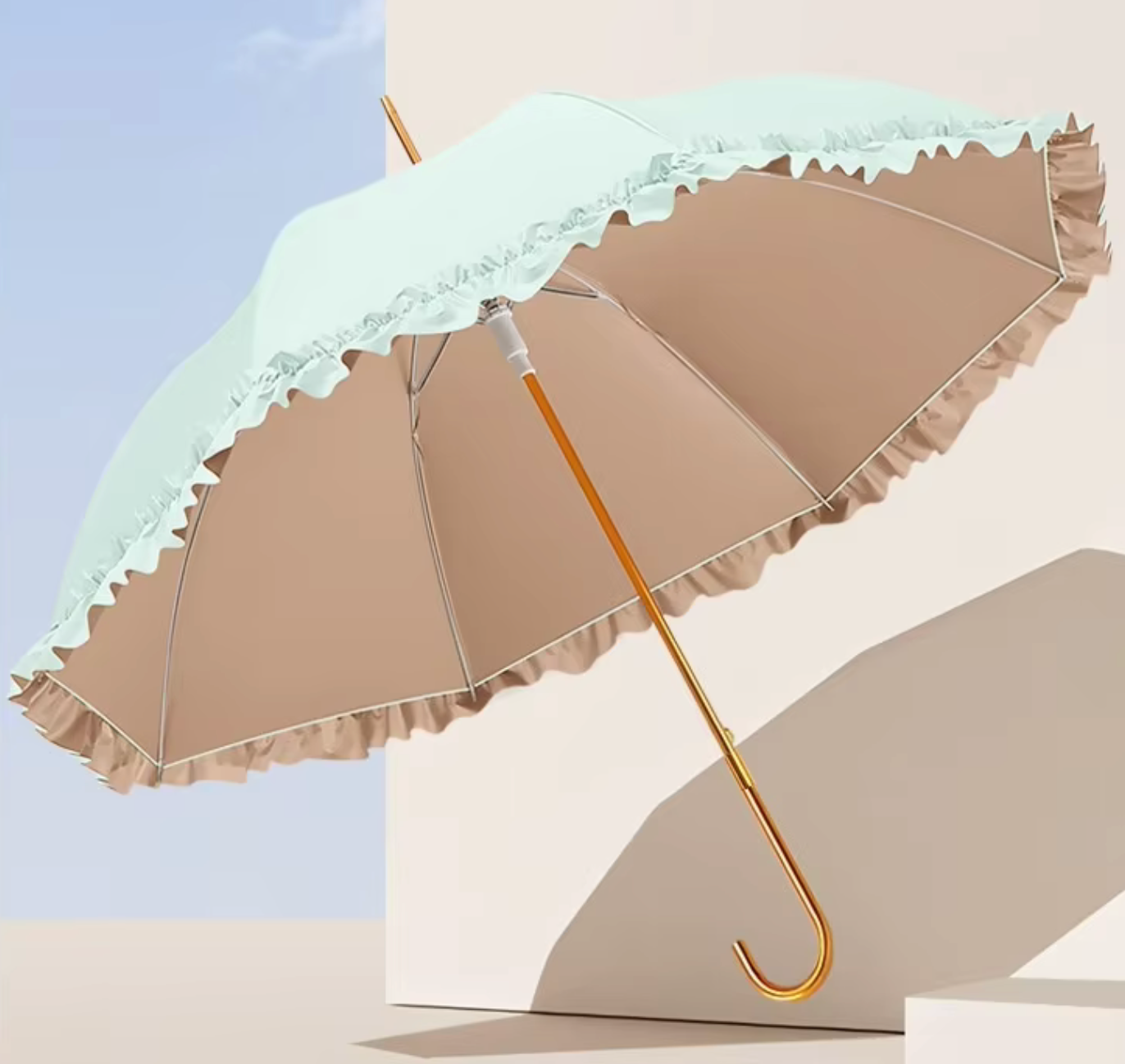 Umbrella with lace trim on a light background