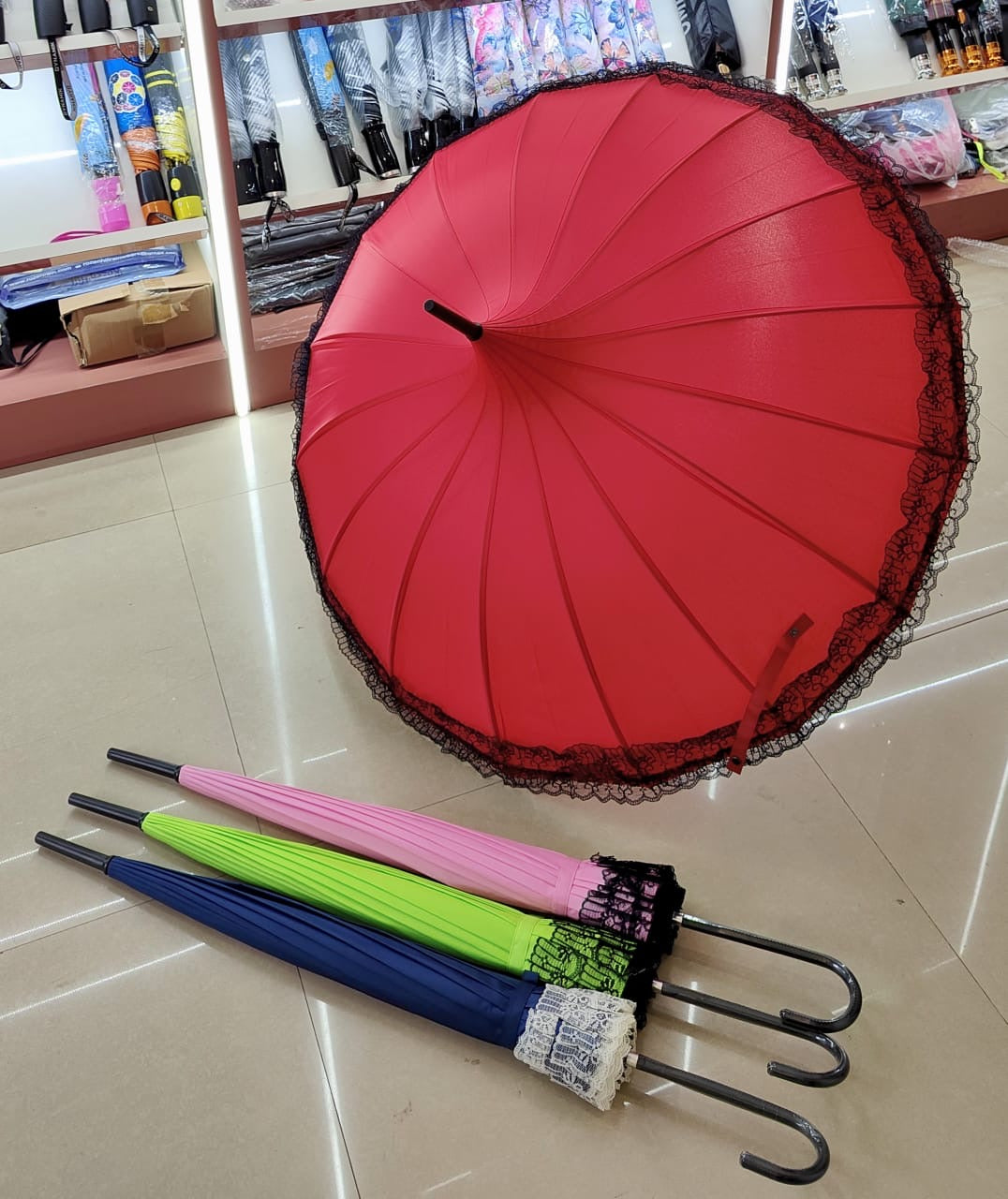 Sky Red umbrella with black lace edge and four other colorful umbrellas