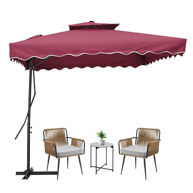 Maroon patio umbrella with two chairs and a small table on a white background
