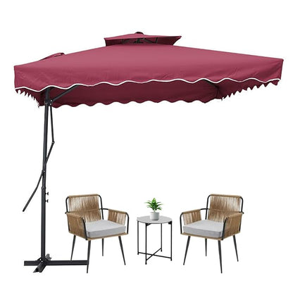 Maroon patio umbrella with two chairs and a small table on a white background