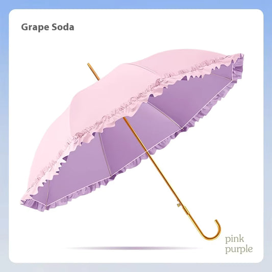 Pink and purple umbrella with decorative trim on a light blue background