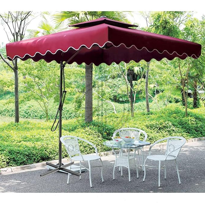 Red patio umbrella with a table and chairs in a garden setting
