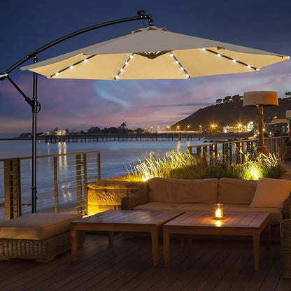 Outdoor patio set with a large solar umbrella overlooking a scenic waterfront at dusk.